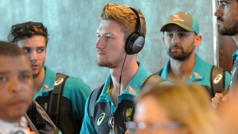 Cameron Bancroft (C) is seen with the the Australian Cricket team as they arrive at Cape Town International Airport on March 27, 2018