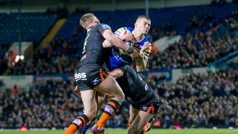 Jack Walker is tackled by Castleford's  Greg Minikin during the Betfred Super League game at Elland Road