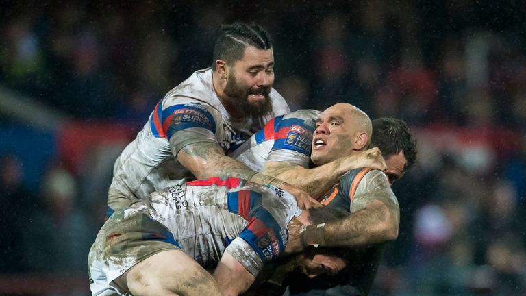 Castleford's Jake Webster is tackled by Wakefield's Anthony England, Scott Grix and David Fifita.