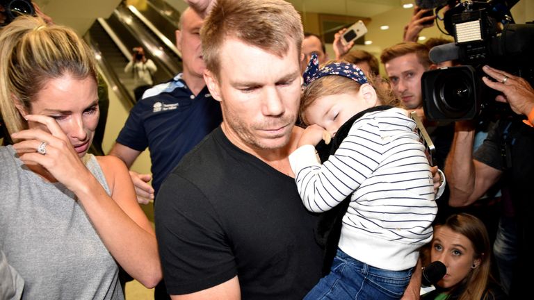 David Warner (C) and his wife Candice after his arrival in Sydney