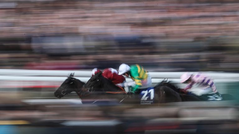 Delta Work ridden by Davy Russell (left) beats Glenloe ridden by Barry Geraghty (no.21) to win the Pertemps Network Final Handicap Hurdle on St Patrick's Thursday at Cheltenham Festival