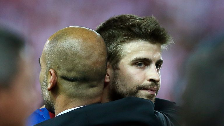 Pep Guardiola embraces Gerard Pique after victory in the Copa del Rey Final between Athletic Bilbao and Barcelona at Vicente Calderon Stadium on May 25, 2012
