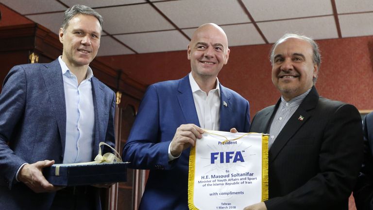 Iran's Minister of Sport and Youth Masoud Soltanifar (R) poses for a picture with FIFA President Gianni Infantino (C)