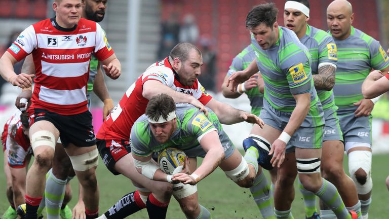 Sean Robinson of Newcastle is tackled by Fraser Balmain of Gloucester