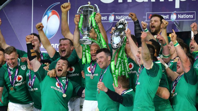Ireland's Peter O'Mahony (C) and teammates celebrate with the trophy after winning the grand slam during the NatWest Six Nations at Twickenham Stadium
