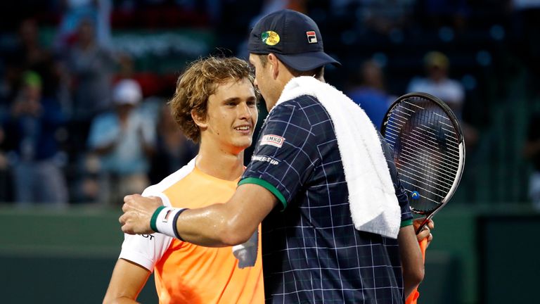 Mar 27, 2017; Miami, FL, USA; Alexander Zverev of Germany (L) hugs John Isner of the United States (R) after their match on day seven of the 2017 Miami Open at Crandon Park Tennis Center. Zverev won 6-7(5), 7-6(7), 7-6(5). Mandatory Credit: Geoff Burke-USA TODAY Sports *** Please Use Credit from Credit Field ***