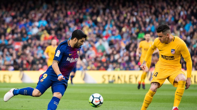 Jose Gimenez goes up against Luis Suarez during Barcelona v Atletico Madrid