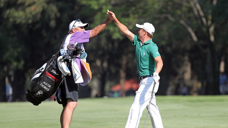 Justin Thomas celebrates with his caddie after his eagle at the 18th in the final round of the WGC-Mexico Championship