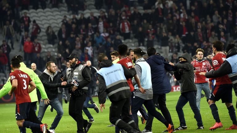 Lille' supporters invade the pitch at the end of the French L1 football match between Lille and Montpellier on March 10, 2018 at the Pierre Mauroy stadium in Lille, northern France