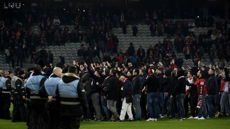 Lille' supporters invade the pitch at the end of the French L1 football match between Lille and Montpellier on March 10, 2018 at the Pierre Mauroy stadium in Lille, northern France