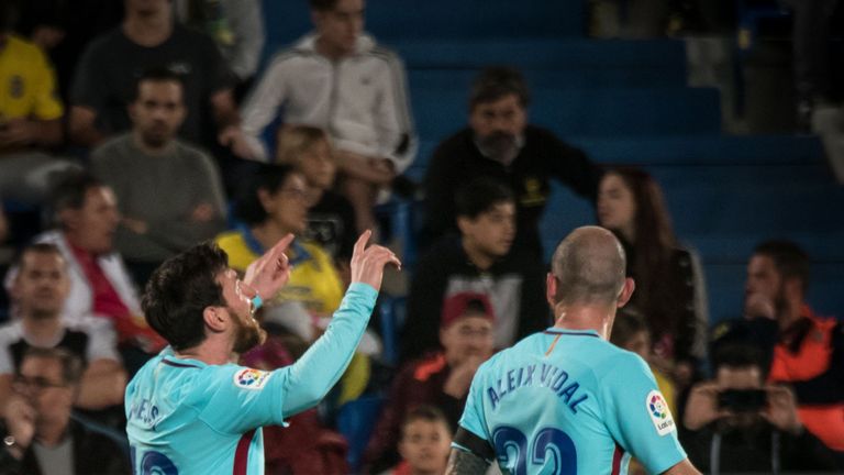 Lionel Messi celebrates with teammate Aleix Vidal after giving Barcelona the lead at Las Palmas