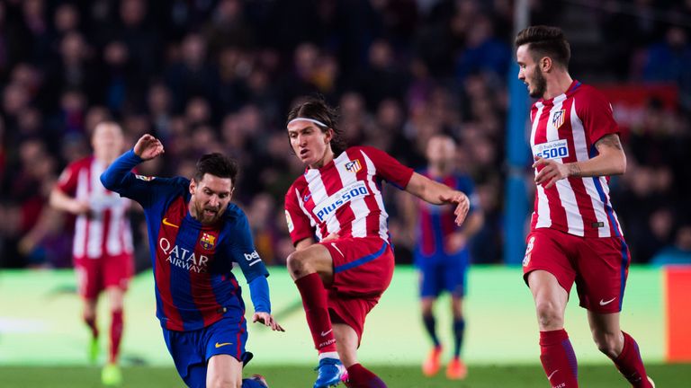 Barcelona's Lionel Messi and Atletico's Filipe Luis battle during last season's Copa del Rey semi-final