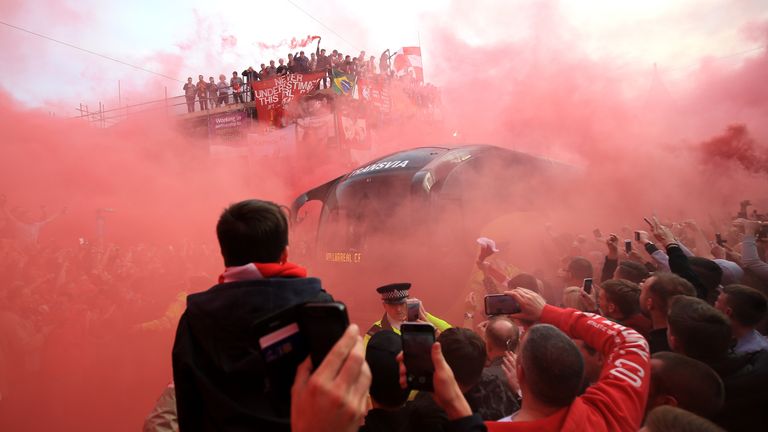 Liverpool fans light flares and surround the Villarreal team bus prior to the game