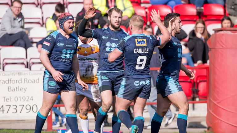 Feartherstone's Luke Briscoe is congratulated after scoring one of his three tries against Batley