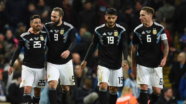Argentina's midfielder Manuel Lanzini (L) celebrates with teammates after scoring their second goal during the International friendly against Italy in Manchester