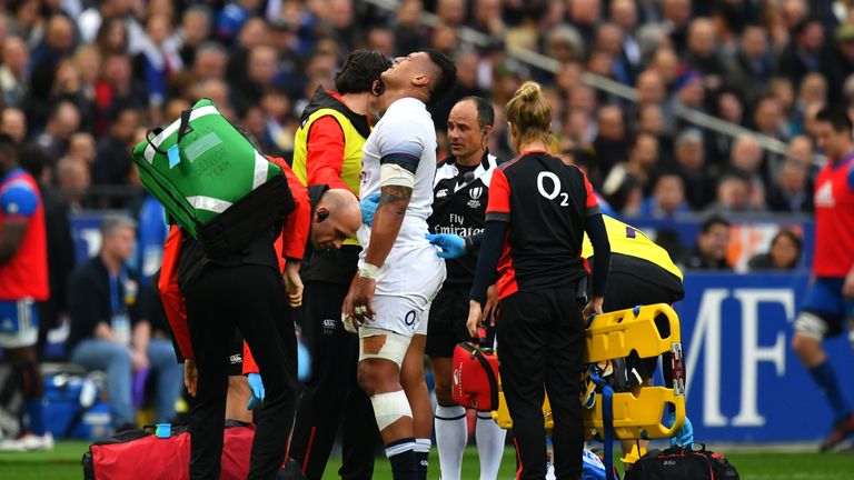Nathan Hughes of England goes off injured against France
