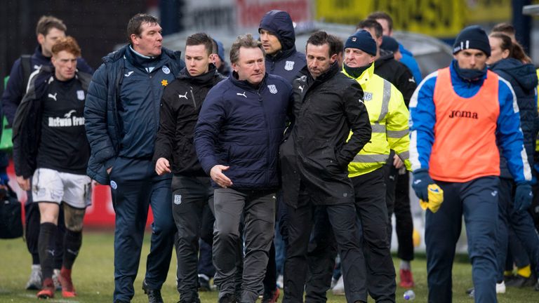 An altercation leads to Neil McCann being escorted away by Dundee youth development coach Jimmy Boyle