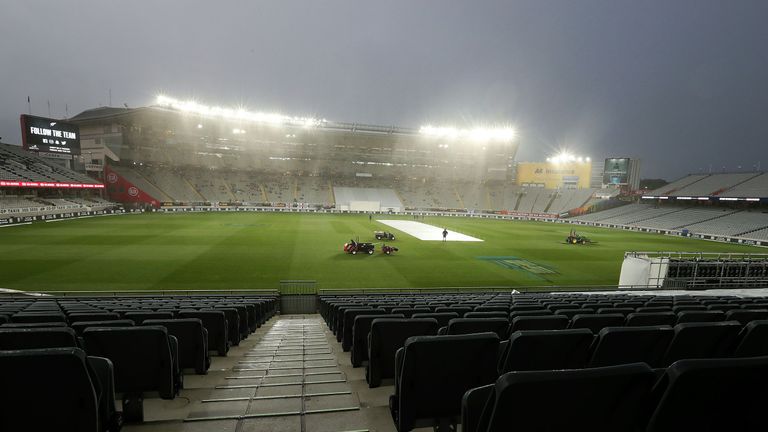 The pitch is cleared after rain delayed play on the second day of the day-night Test cricket match between New Zealand and England at Eden Park in Auckland on March 23, 2018. 