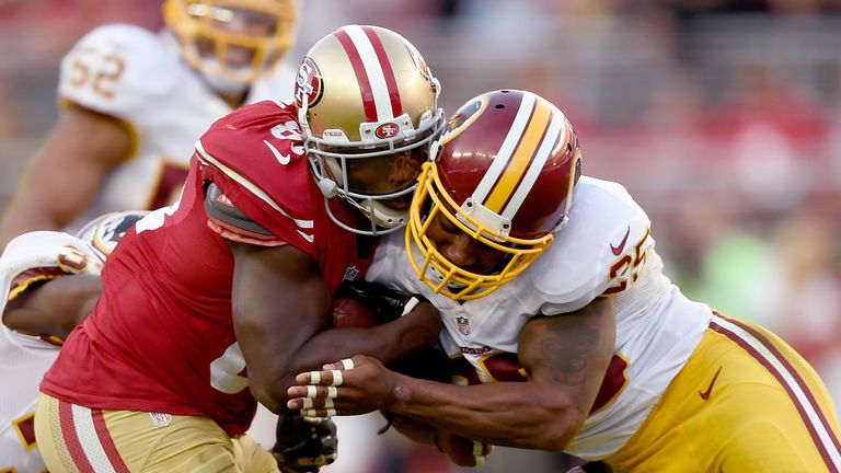Ryan Clark #25 of the Washington Redskins (R) gets penalized for a helmet to helmet hit on Anquan Boldin #81 of the San Francisco 49ers in 2014