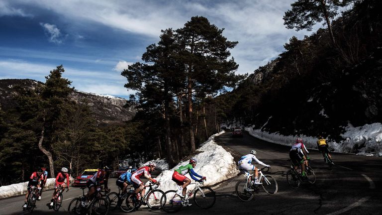 Cyclists ride in a breakaway past snow during the seventh stage of the Paris - Nice cycling race between Sisteron and Vence