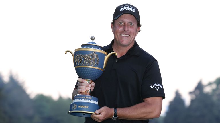 Phil Mickelson proudly displays the Gene Sarazen trophy after winning the WGC-Mexico Championship