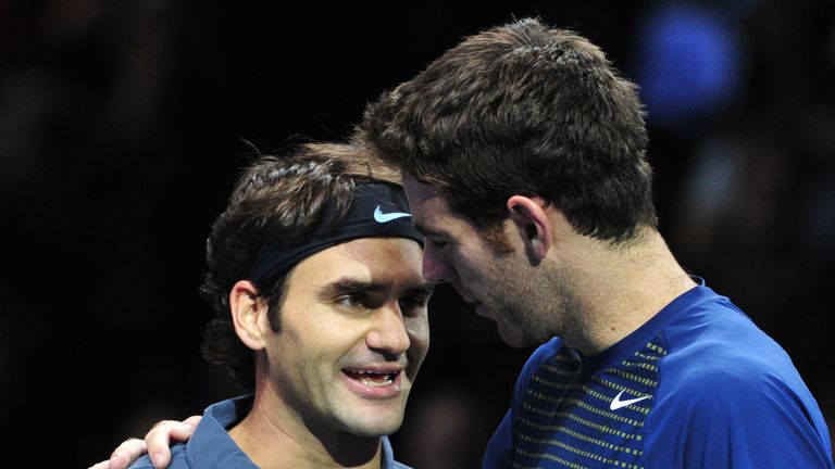 Switzerland's Roger Federer (L) talks with Argentina's Juan Martin Del Potro (R) after winning their group B singles match in the round robin stage on the sixth day of the ATP World Tour Finals tennis tournament in London on November 9, 2013. Federer won 4-6, 7-6, 7-5.