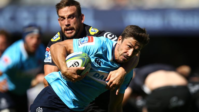 Keegan Daniel of the Sharks tries to stop the march of Waratah's Jake Gordon 