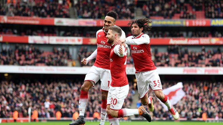 Shkodran Mustafi celebrates scoring Arsenal's first goal against Watford with Pierre-Emerick Aubameyang and Mohamed Elneny 
