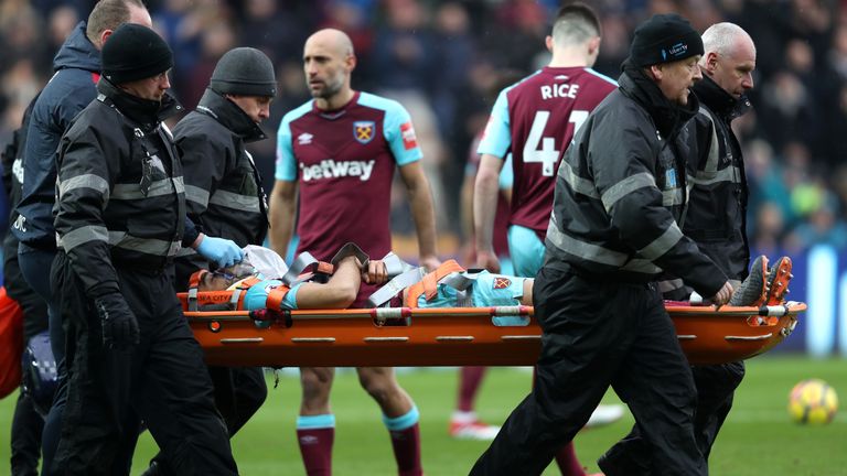 Winston Ried is carried of the pitch on a stretcher after appearing to twist his knee