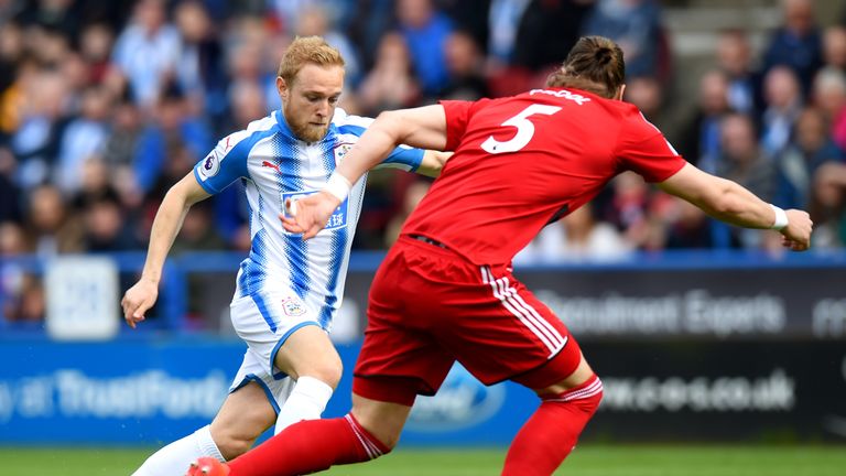 Alex Pritchard takes on Sebastian Prodl during the Premier League match between Huddersfield Town and Watford at John Smith's Stadium