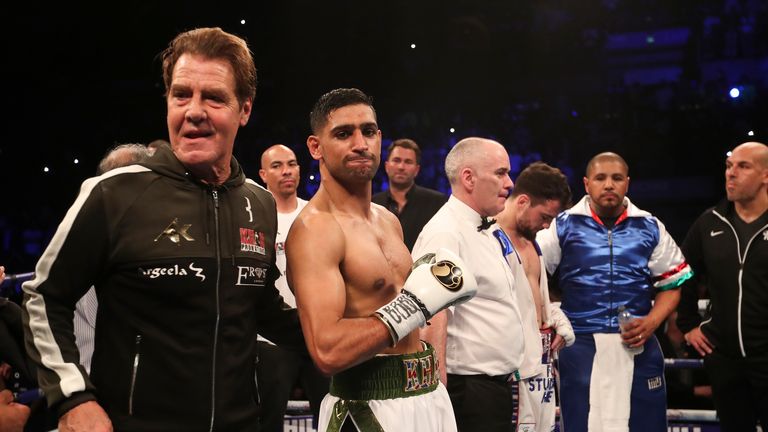 Amir Khan and new trainer Joe Goossen wait for the hand to be raised