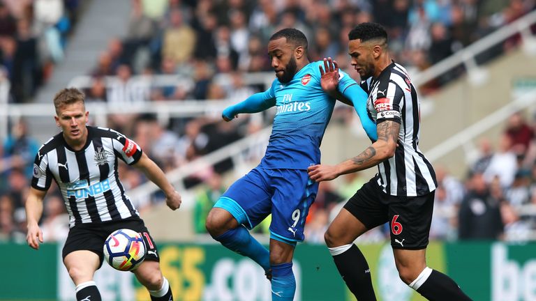 Arsenal's Alexandre Lacazette views for the ball with Newcastle defender Jamaal Lascelles
