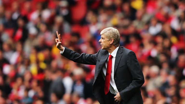 Arsene Wenger gives his team instructions during the Barclays Premier League match between Arsenal and Stoke City at the Emirates Stadium on September 22, 2013