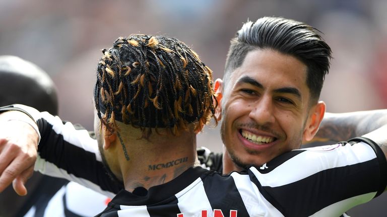 Ayoze Perez celebrates with teammate Deandre Yedlin after scoring his sides first goal during the Premier League match between Newcastle United and Arsenal at St James' Park on April 15, 2018