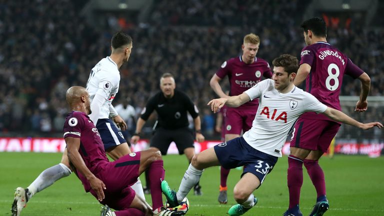 Tottenham Hotspur's Ben Davies challenges Manchester City's Vincent Kompany off the ball during the Premier League match at Wembley Stadium