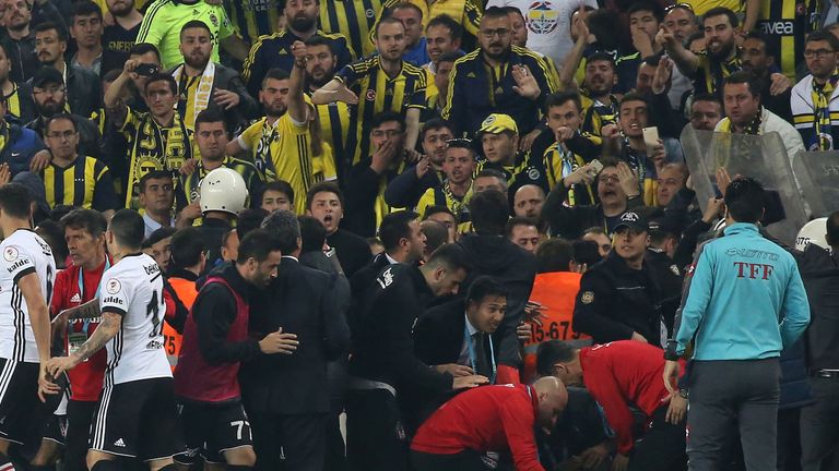 Besiktas head coach Senol Gunes received first aid on the pitch for a head injury 