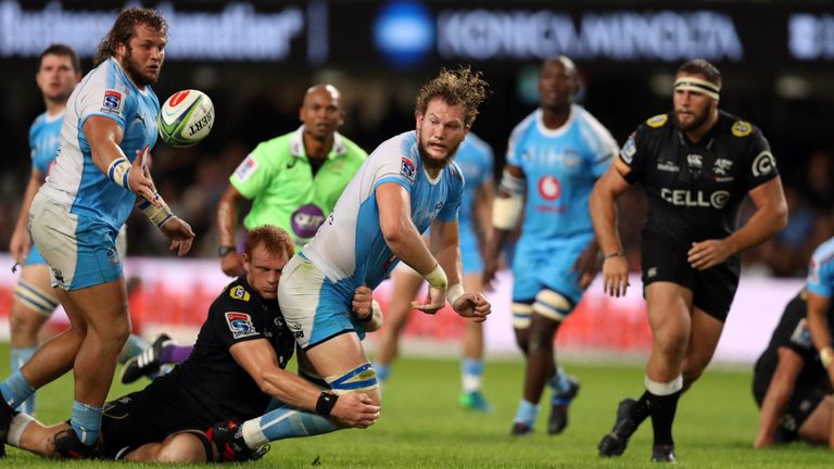 RG Snyman of the Bulls offloads the ball after a tackle by Philip van der Walt