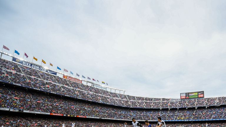 Denis Suarez competes with Jeison Murillo and Dani Parejo during the La Liga match between Barcelona and Valencia at Camp Nou on April 14, 2018