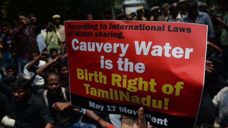 Indian members of the Tamil ethnic group hold placards and shout slogans during a protest
