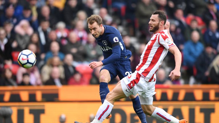 Christian Eriksen takes a shot on goal under pressure from Erik Pieters at the Bet365 Stadium