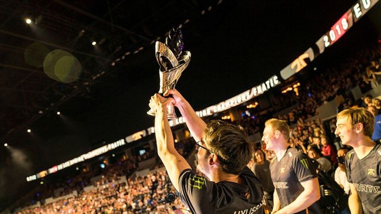 Members of Fnatic raise the trophy after sweeping the finals