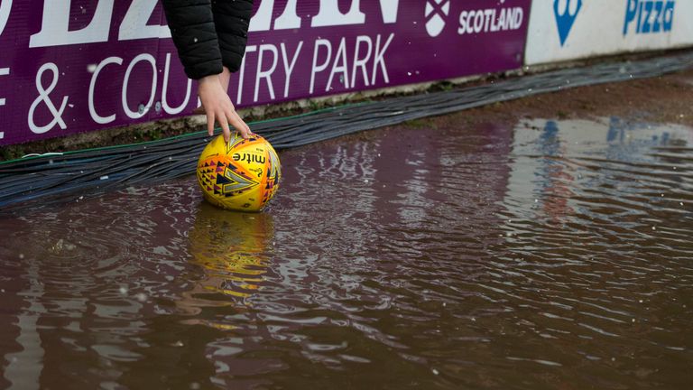 The match ball is recovered from a puddle at Somerset Park                                                                                                                                              