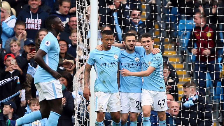 Manchester City's Gabriel Jesus (left) celebrates scoring his side's fifth goal against Swansea