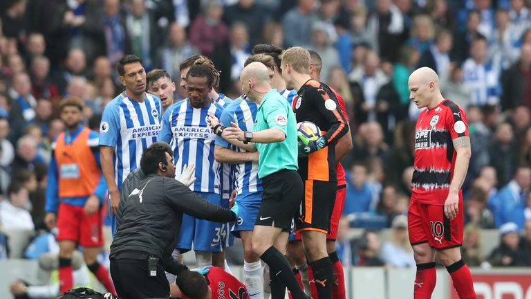 The Huddersfield midfielder receives medical treatment following Propper's foul