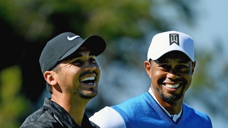 Jason Day of Australia and Tiger Woods share a laugh on the fourth hole during the first round of the Farmers Insurance Open at Torrey Pines South on January 26, 2017