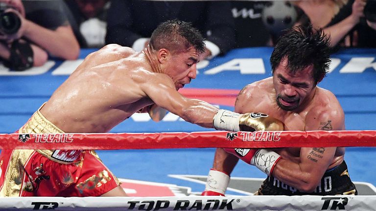Jessie Vargas (L) hits Manny Pacquiao with a right in the sixth round of their WBO welterweight championship fight at the Thomas & Mack Center on November 5, 2016.