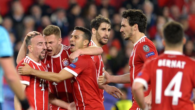 Bayern players celebrate Sevilla's Spanish midfielder Jesus Navas' own goal during the UEFA Champions League quarter-final first leg football match between Sevilla FC and Bayern Munich at the Ramon Sanchez Pizjuan Stadium in Sevilla on April 3, 2018