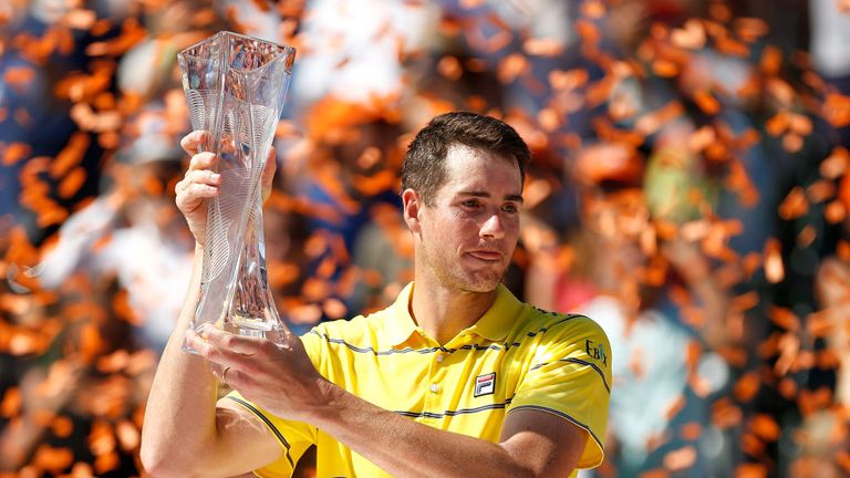 John Isner of the United States poses for a photo with the Butch Buchholz Trophy after defeating Alexander Zverev of Germany in the men's final on Day 14 of the Miami Open Presented by Itau at Crandon Park Tennis Center on April 1, 2018 in Key Biscayne, Florida