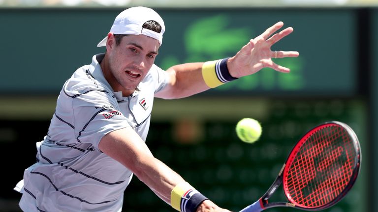 John Isner returns a shot to Alexander Zverev of German during the men's final of the Miami Open Presented by Itau at Crandon Park Tennis Center on April 1, 2018 in Key Biscayne, Florida