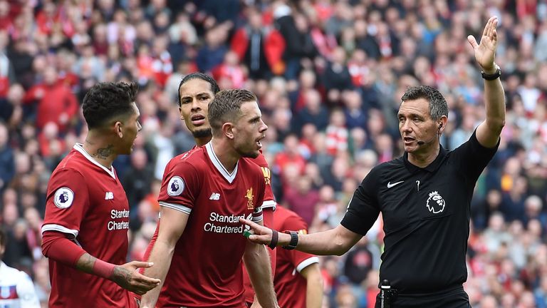 Liverpool's Jordan Henderson and Roberto Firmino appeal for handball against Stoke City's Erik Pieters (not pictured) at Anfield